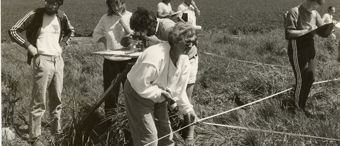 black and white photograph of researchers in field