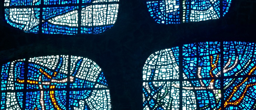 photograph of four blue stained glass windows